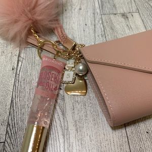 Pink keychain wallet with Broadway rosehip oil
